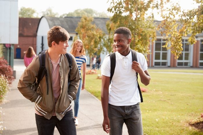 Two young men walking through school