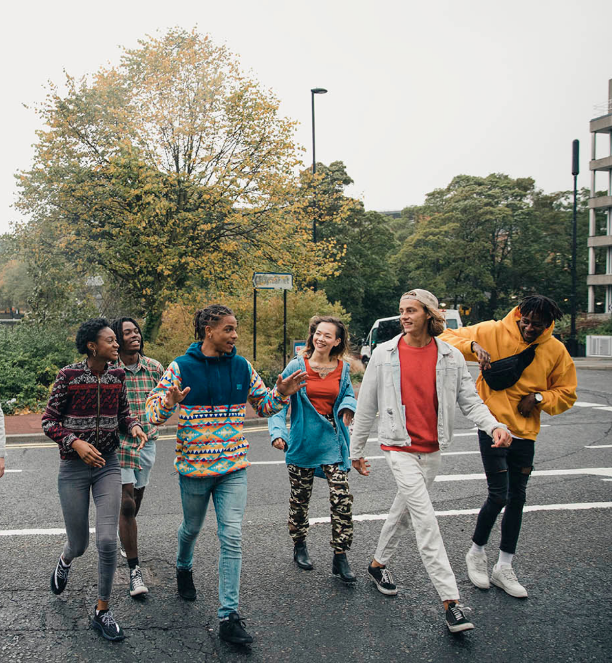 Group of happy and diverse young people walking on the street